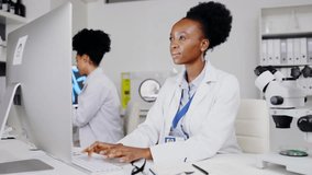 Scientist, computer and black woman writing research data, results or information in lab. Science, notebook and happy female medical doctor typing and write notes in book with desktop for healthcare. - Powered by Shutterstock - Get 15% off with code: PIKWIZARD15