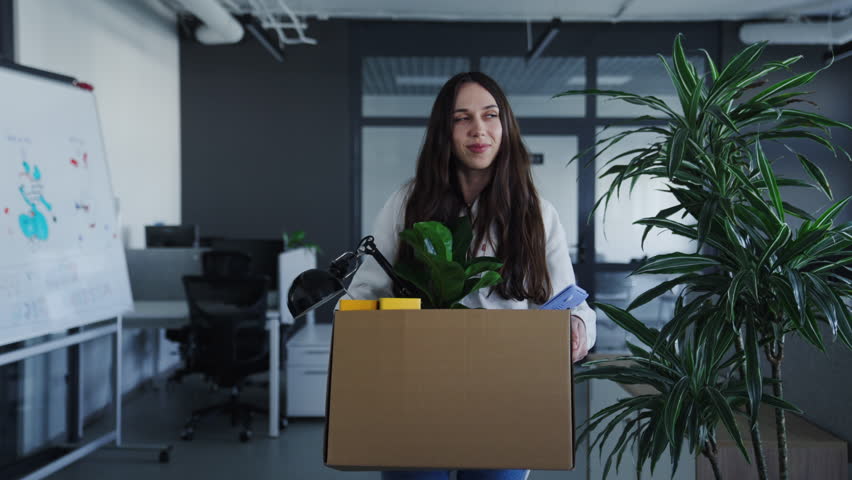 A new employee in the office. A young woman walks through the open space and looks at her new workplace with pleasure Royalty-Free Stock Footage #1101673515