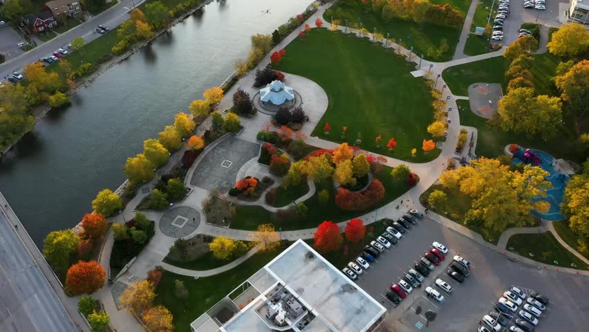 Aerial view of a river flowing past a Mississauga park at sunrise.