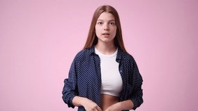 4k video of one girl emotionally rejoices over pink background.
