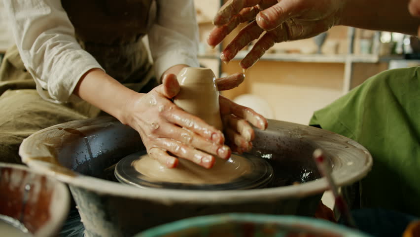 Pottery workshop potter works with potter's wheel product made of clay potter conducts master class