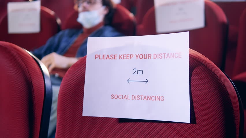 Signs of social distancing in the cinema hall with one man being in it