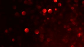 Floating Red Bokeh Particles. Abstract motion background of defocused red bokeh lights on dark.  - Powered by Shutterstock - Get 15% off with code: PIKWIZARD15