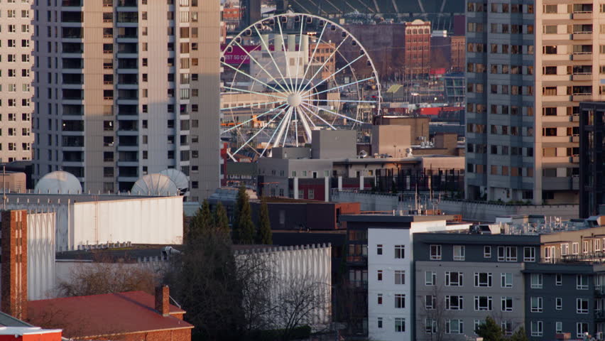 Downtown Seattle Ferris Wheel at Sunset. Tilt Up Reveal of Tourist Attraction Ride in Seattle Washington