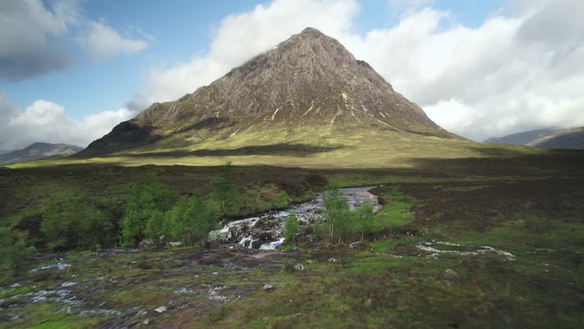 Buachaille Etive Mor Towers Over Cloudy River Laced Marshland, Rannoch Moor Royalty-Free Stock Footage #1101688371