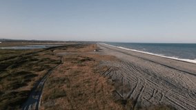 Man sitting on car and taking in beautiful sunset view at an empty beach - Powered by Shutterstock - Get 15% off with code: PIKWIZARD15