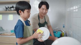 Asian father teaching son to wash dishes in the kitchen at home. Single father concept - Powered by Shutterstock - Get 15% off with code: PIKWIZARD15