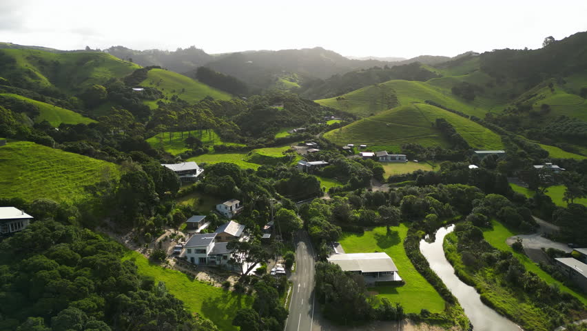 aerial scenic natural landscape footage of green hills scenario in New Zealand Ngunguru, north island