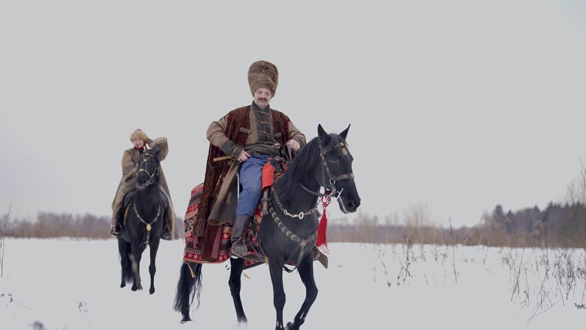 Polish or Russian nobility of 12 century, man and woman riding horse, historical reconstruction