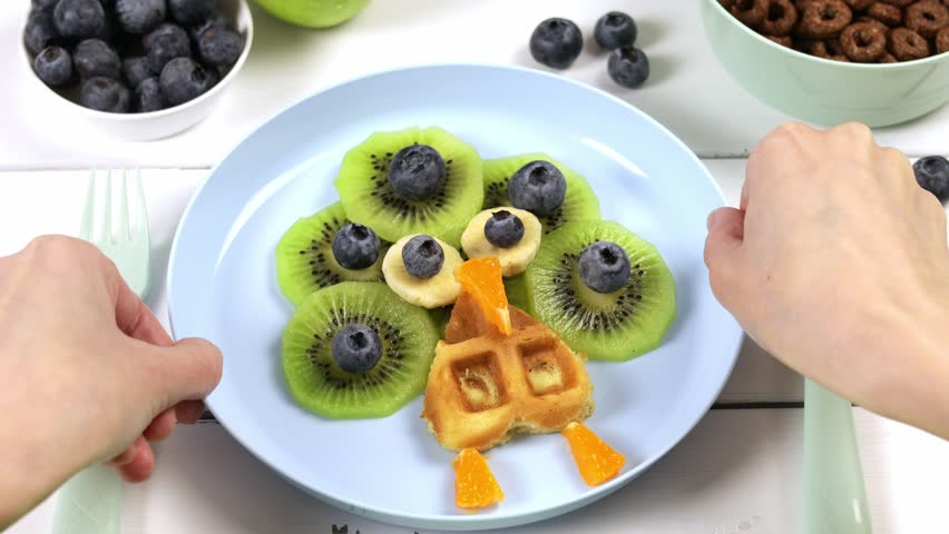Peacock waffle for children's breakfast. Adorable art food for kids in the shape of animals. A creative idea for a fun kids dessert or breakfast Royalty-Free Stock Footage #1101702429