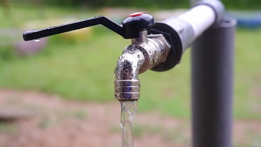 An iron faucet that slowly dispenses clear water | Shutterstock HD Video #1101702777