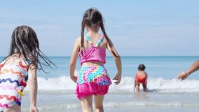 Group of Diversity little child boy and girl friends running and playing sea water at tropical beach together on summer vacation. Happy children kids enjoy and fun outdoor lifestyle on beach holiday. - Powered by Shutterstock - Get 15% off with code: PIKWIZARD15