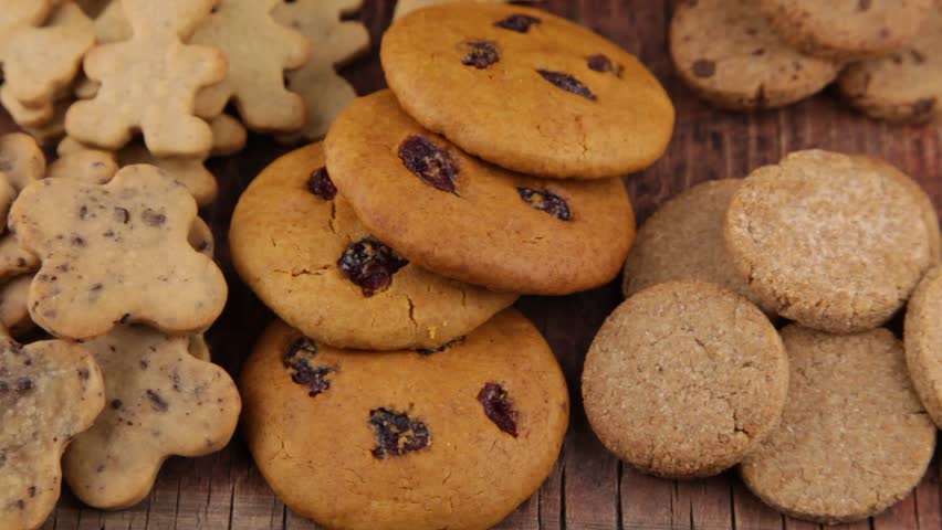 Set of different homemade cookies. Cookie close-up. Background from delicious pastries. Cookies with coconut, mishdal, chocolates, raisins, lingonberries. Round rhombuses, bears flowers shapes.