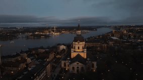 Aerial video of Katrina Church in the background of the capital city of Stockholm, Sweden, in the evening.