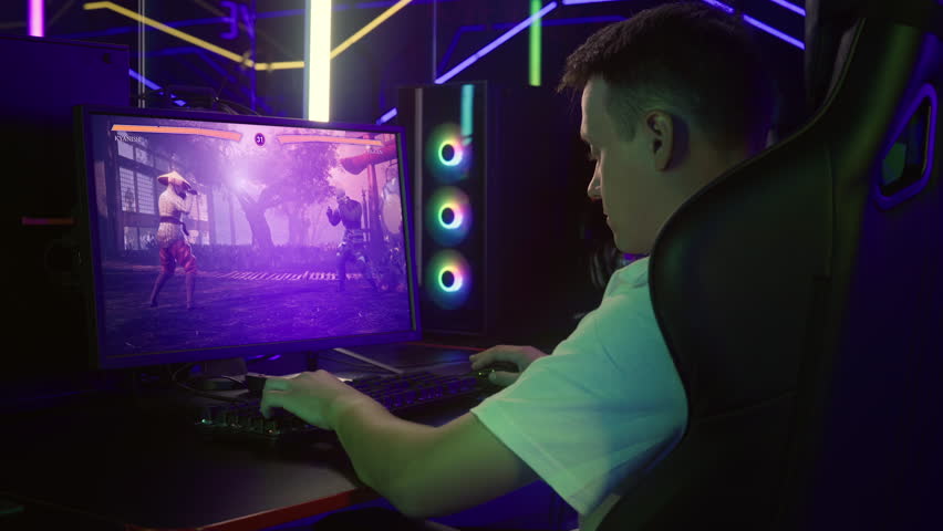 Player enjoying the newest fighting video game. Controlling the character in the fighting video game. Hitting the opponent hero with powerful combos in the versus fighting video game. Vs. | Shutterstock HD Video #1101710259