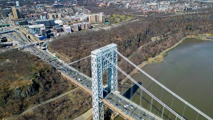 The George Washington Bridge is a suspension bridge that spans the Hudson River between Fort Lee in Bergen County, New Jersey, and Upper Manhattan in New York City.