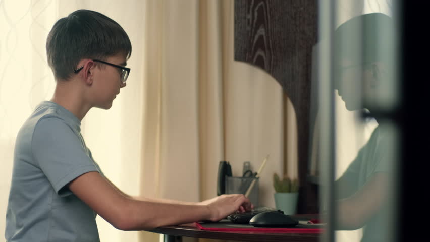 Using ChatGPT.Chat GPT.Artificial Intelligence.Boy writes program code at home using computer.Authentic Action,Home Window,Sun Flare,Bright Light - Powered by Shutterstock - Get 15% off with code: PIKWIZARD15