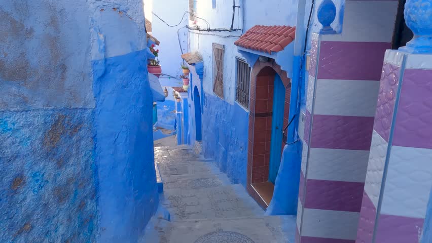 Walk through alley of traditional houses, blue facades of Chefchaouen city, Blue Pearl of Morocco Royalty-Free Stock Footage #1101712743