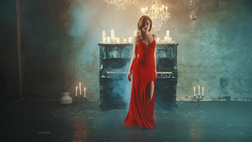 Dark Silhouette fantasy lady gothic beautiful woman blond hair in red dress walks in luxurious room black piano candles light burn. Evening dress slit on long leg fashion model sexy girl vampire queen