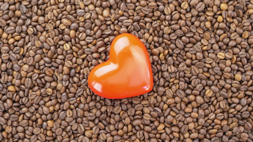 Roasted coffee beans with a red heart shape. Coffee lovers concept