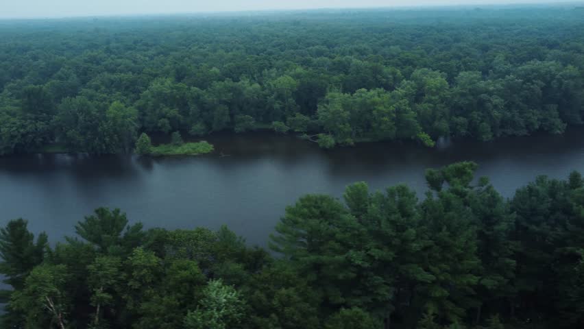 Wisconsin River Aerial drone dolly along side on hazy summer day