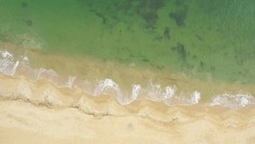 Summer is coming video. Sandy beach, panorama. Top view Aerial of the sandy beach. The sea wave rolls on the shore. Sea coast view from the air