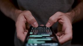 Young man holding a mobile phone close up, using it to write and send messages. Concept mobile technology,5G, people share and read SMS messages. - Powered by Shutterstock - Get 15% off with code: PIKWIZARD15