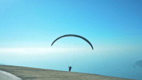 Panorama with blue sky, mountains and paraglider. 4k footage UHD 3840x2160