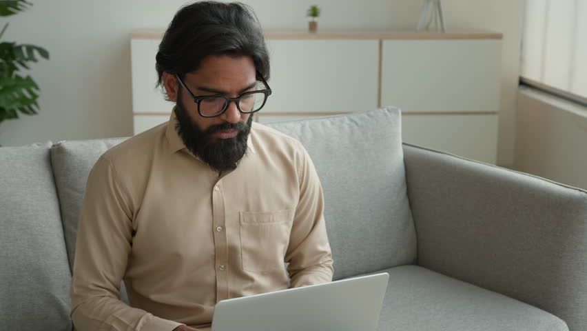 Tired exhausted freelancer working with laptop at home overworked Arabian muslim man fall asleep on couch sick weary sleeping Indian businessman lean on sofa exhaustion fatigue need break rest relax Royalty-Free Stock Footage #1101721321
