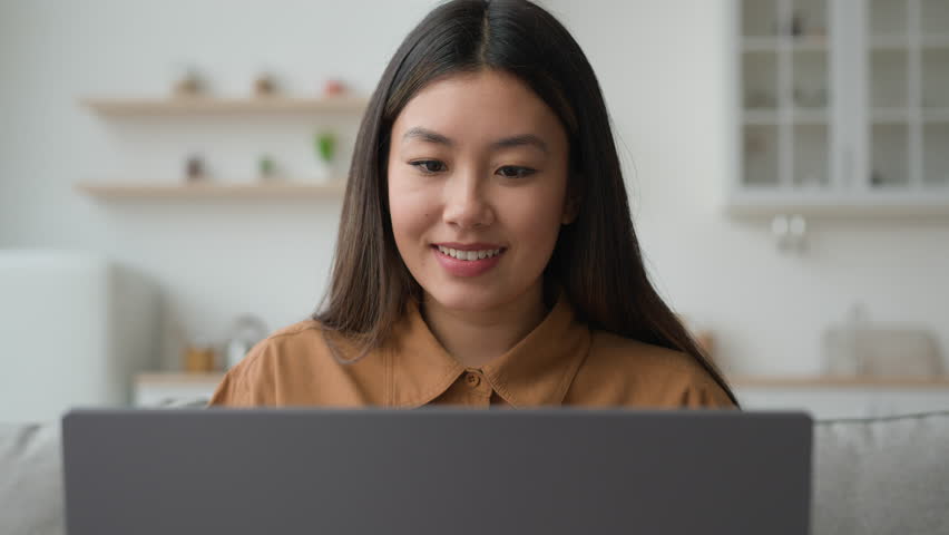 Asian woman typing laptop in kitchen korean vietnamese businesswoman working from home smiling millennial ethnic chinese girl browsing net shopping online web store texting e-mail order food delivery Royalty-Free Stock Footage #1101721353