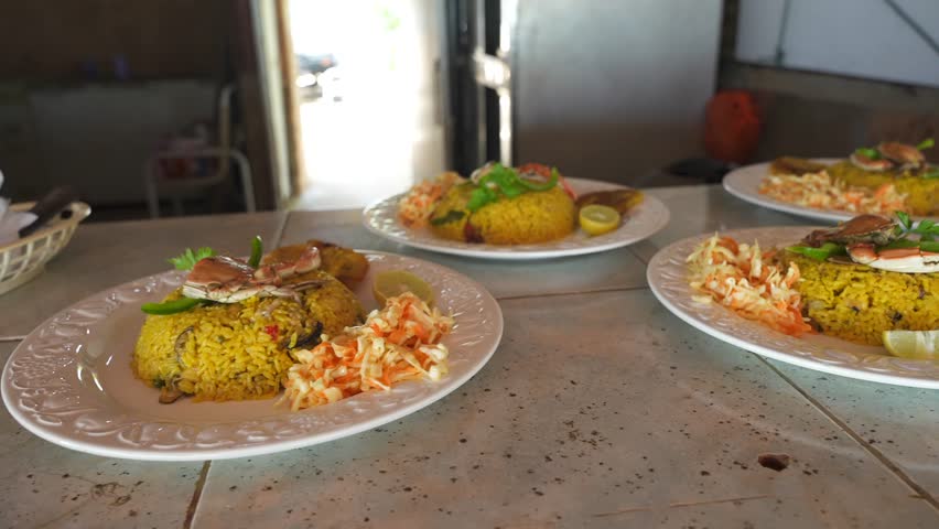 Typical Latin American dinner at the beach. Yellow rice with seafood for tourists in the street restaurant
