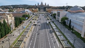 Aerial long view of Avinguda de la Reina Maria Cristina at its junction with Montjuic Palace in background. This iconic square is located at foot of Montjuic major landmark in Barcelona. 4K video