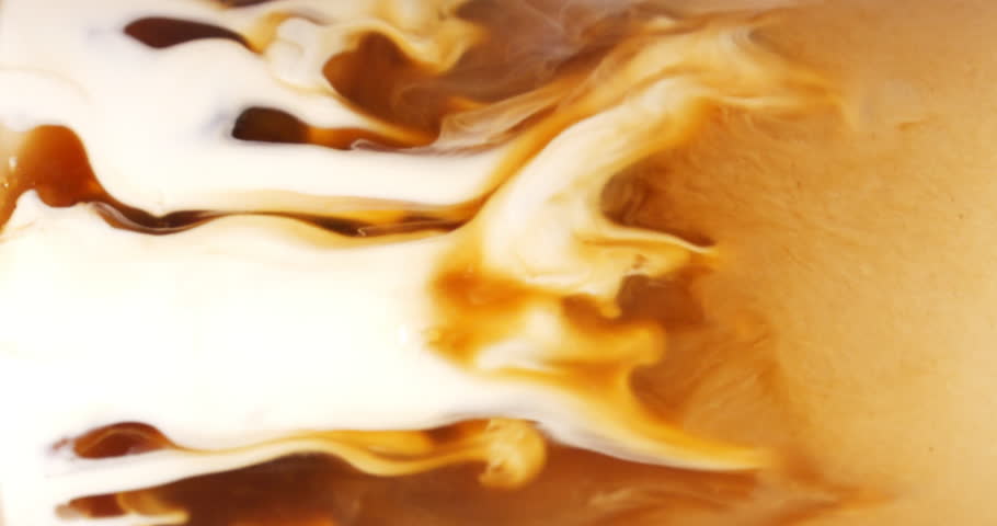 4K footage vertical video front view SLO MO CU, flowing milk blending homogenously with coffee in glass on the table, coffee art concept.	 Royalty-Free Stock Footage #1101724397