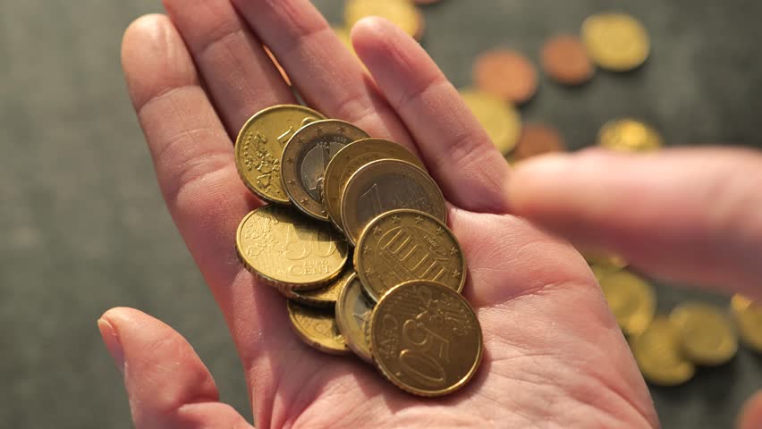 Hand collects euro cents.Lack of money.Euro coins in hand . Insufficient small salary.Salaries, pensions and benefits in the European Union. Euro currency.Money and finance. 4k footage Royalty-Free Stock Footage #1101726495