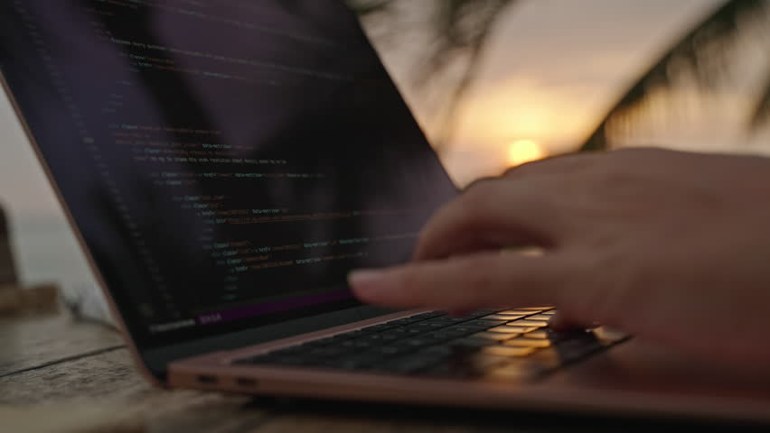 Female developer working on laptop by the ocean. Young woman freelancer coding at outdoor tropical cafe. Caucasian girl working remotely typing on computer at exotic location close-up. Worldwide work. | Shutterstock HD Video #1101728611