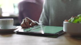 Woman, tablet and remote work in cafe for graph, chart and information on app for analysis. Coffee shop, table and woman with mobile tech for data analytics, reading and report for finance planning - Powered by Shutterstock - Get 15% off with code: PIKWIZARD15