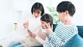 Asian family using smart phone in living room.