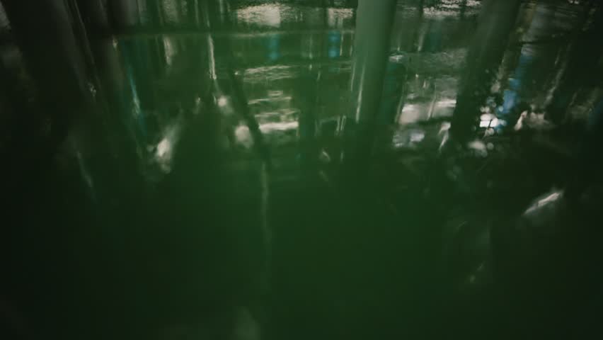 Industrial beer brewery production hall with stainless pipes and brewing tanks