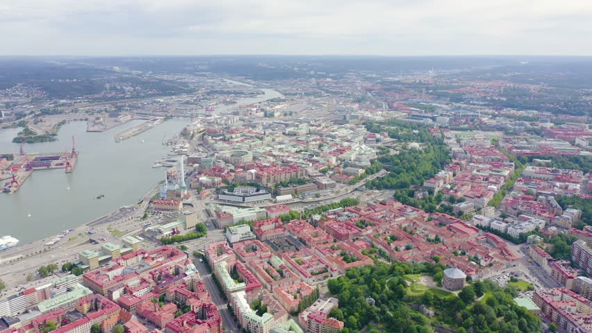 Inscription on video. Gothenburg, Sweden. Panorama of the city and the river Goeta Elv. The historical center of the city. Cloudy weather. Text from small balls, Aerial View