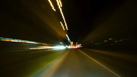 Fast Speed City Drive Timelapse. City Road and Glittering Streets and Buildings All Turning Into Colorful Light Trails. Cityscape Hyperlapse Road Trip. Windshield View