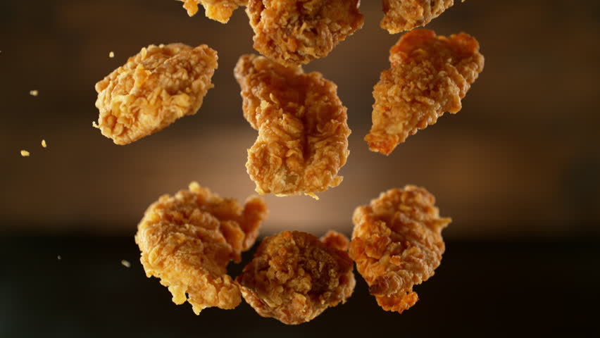 Super Slow Motion Shot of Flying Fresh Fried Chicken Wings or Strips. Camera Move. Filmed on High Speed Cinematic Camera at 1000 fps. Royalty-Free Stock Footage #1101739671