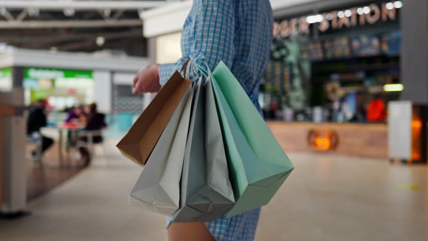 Shopper, Shopper chooses clothes Slowly Walks through the super store In the mall, In slow motion Pretty woman Shopping in a fashion store To have fun, shopping bag
 Royalty-Free Stock Footage #1101741145