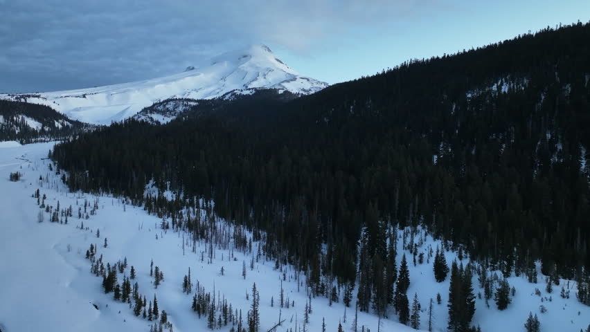 Snow covers Mt Hood, a beautiful stratovolcano found about 50 miles southeast of Portland, Oregon. Mt Hood has one of the longest ski seasons in the U.S. due to its annual snow pack.