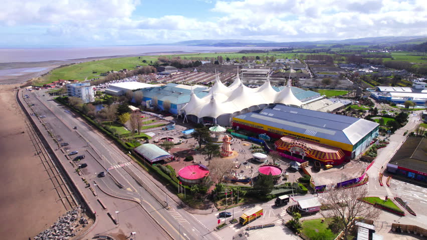 Aerial shot flying towards Butlins holiday camp and beach in Minehead, Somerset. UK Royalty-Free Stock Footage #1101753455