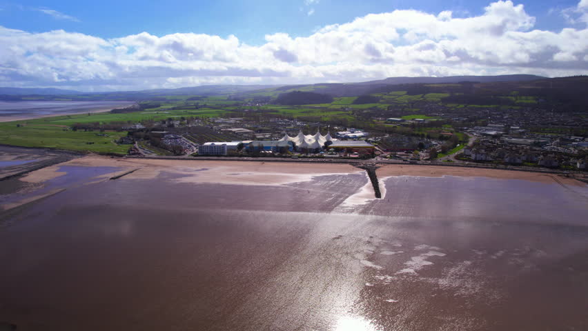 Aerial shot flying towards Butlins holiday camp and beach in Minehead, Somerset. UK Royalty-Free Stock Footage #1101753457