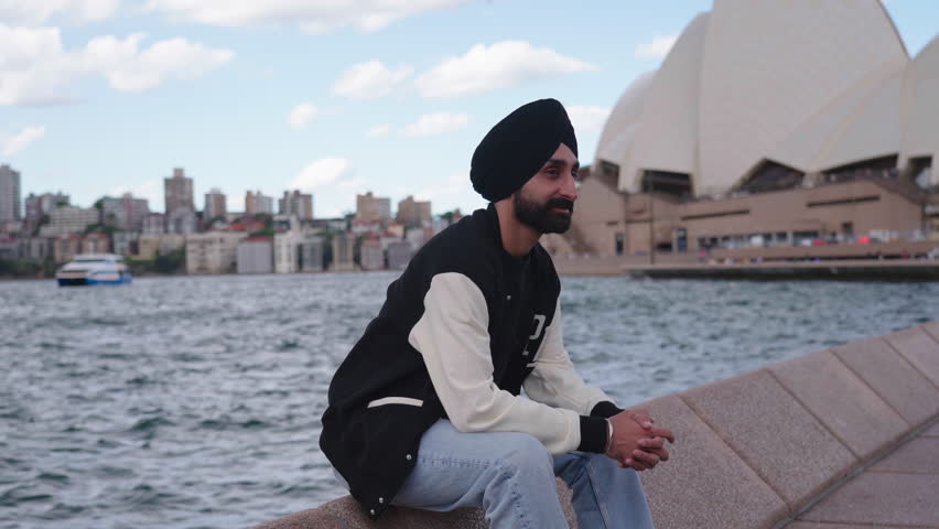 Indian Man In Turban Sitting In Front Of Famous In Sydney, Australia. - wide