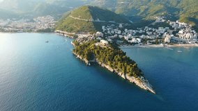 Bird's eye view of towns of Budva and Becici with hotels and beaches near Adriatic Sea against the backdrop of the Montenegrin Mountains