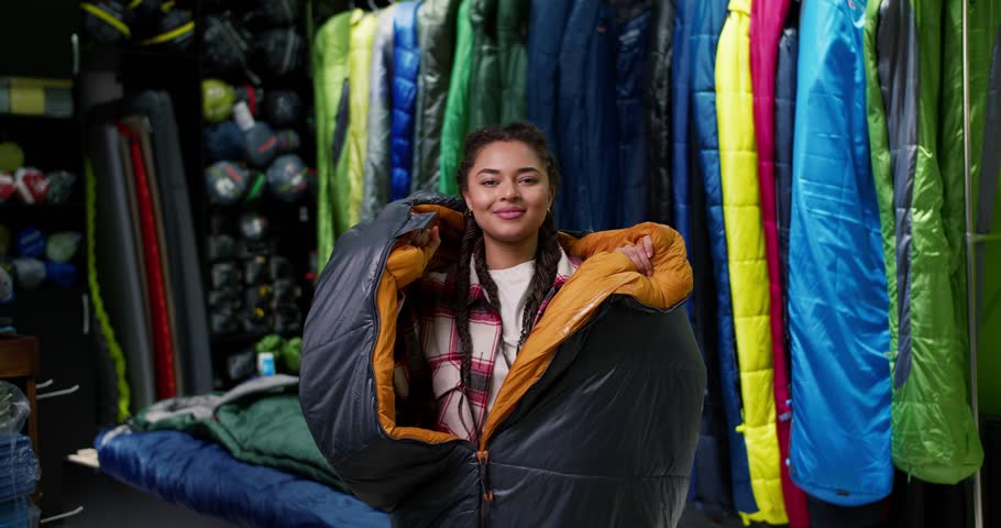 Closeup of a woman covered in sleeping bag at tourist store