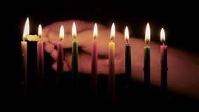 Burning colored Hanukkah candles. Lights candles with a match. Close up shot - Powered by Shutterstock - Get 15% off with code: PIKWIZARD15