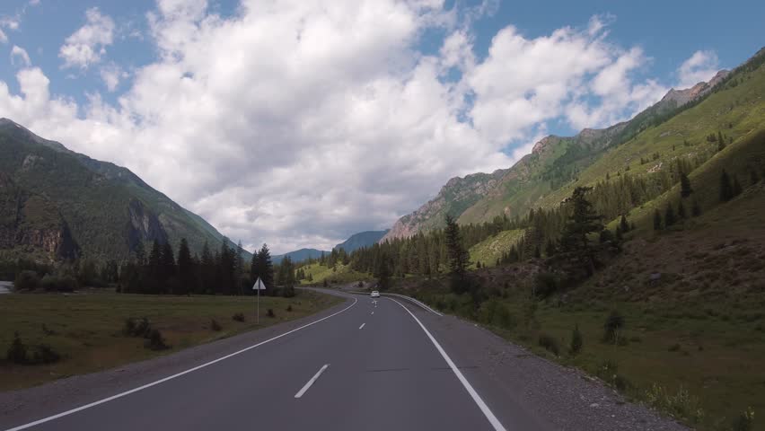 Driving in a car In summer season along the mountain road of the Chuya Highway or the Chuysky Trakt in Altai. border between Ulagansky and Ongudaysky districts. Siberia, Russia